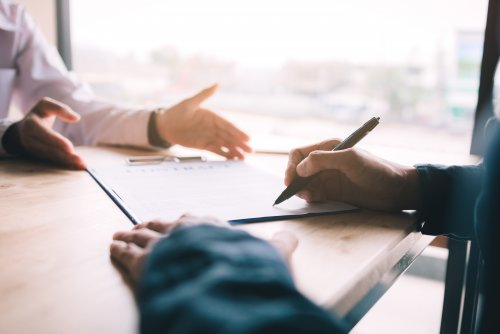 real-estate-contract-on-desk-with-client-signing-i-2021-09-03-09-39-02-utc.jpg